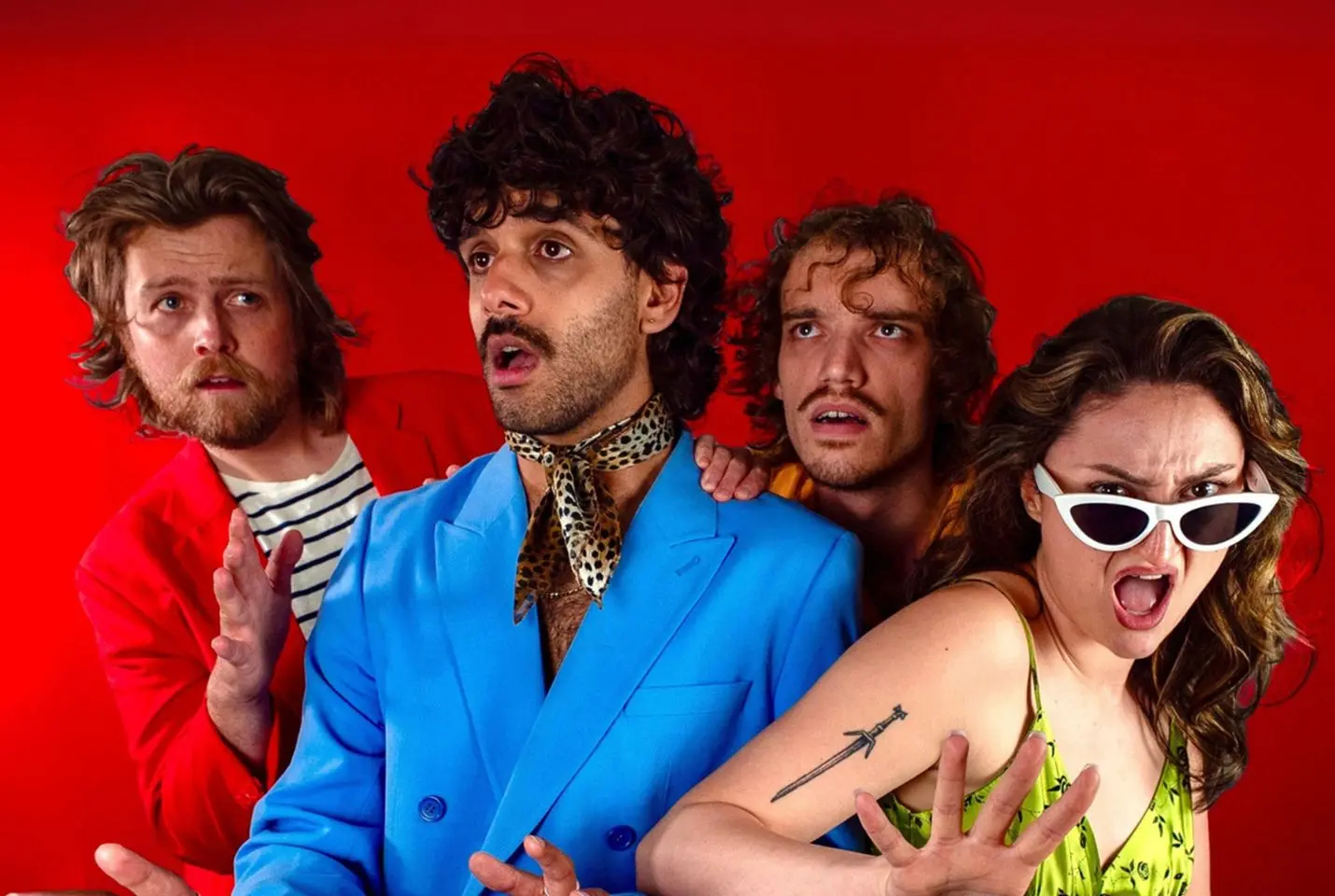 Four people in front of a red backdrop