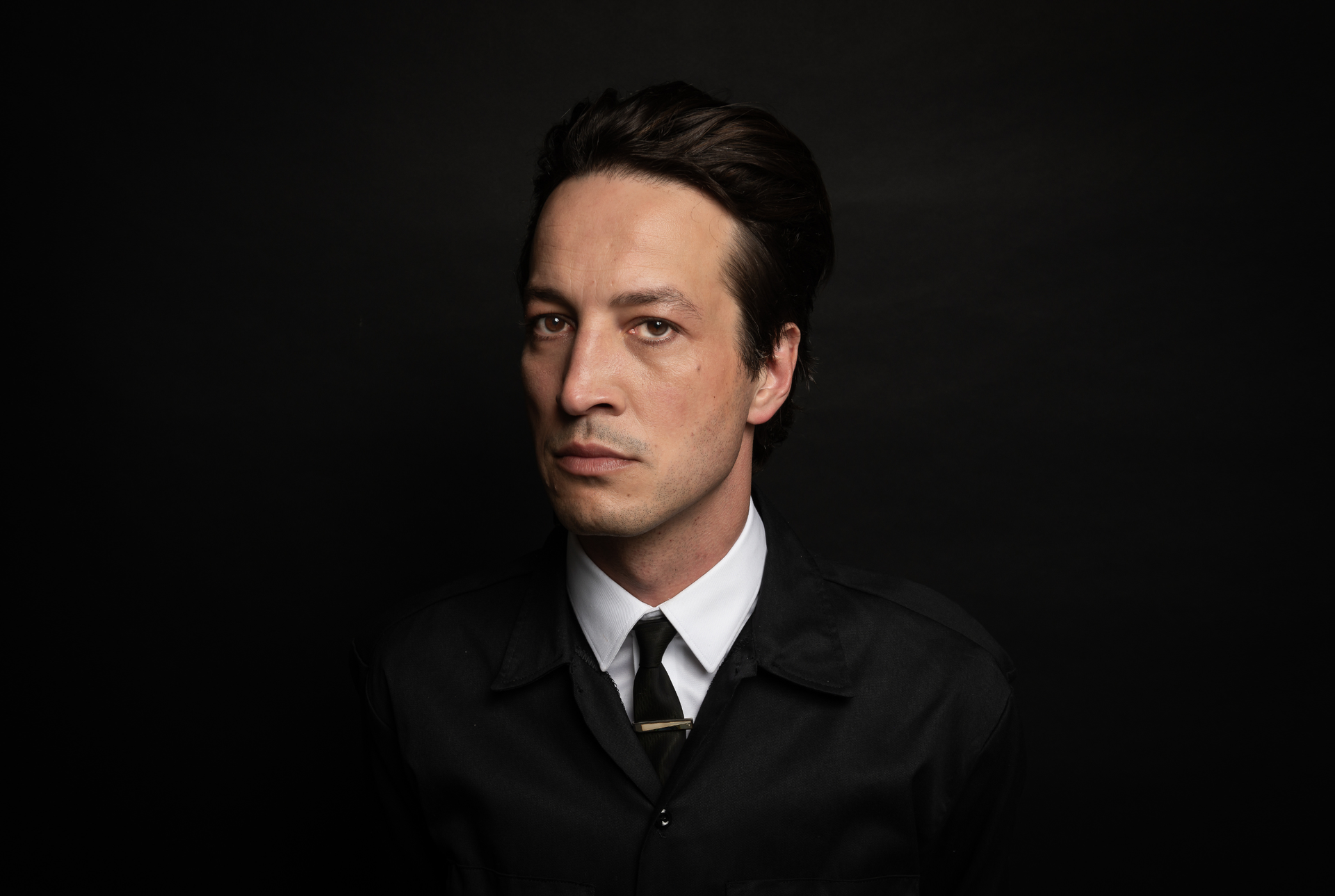 Musician Marlon Williams in front of a black background.