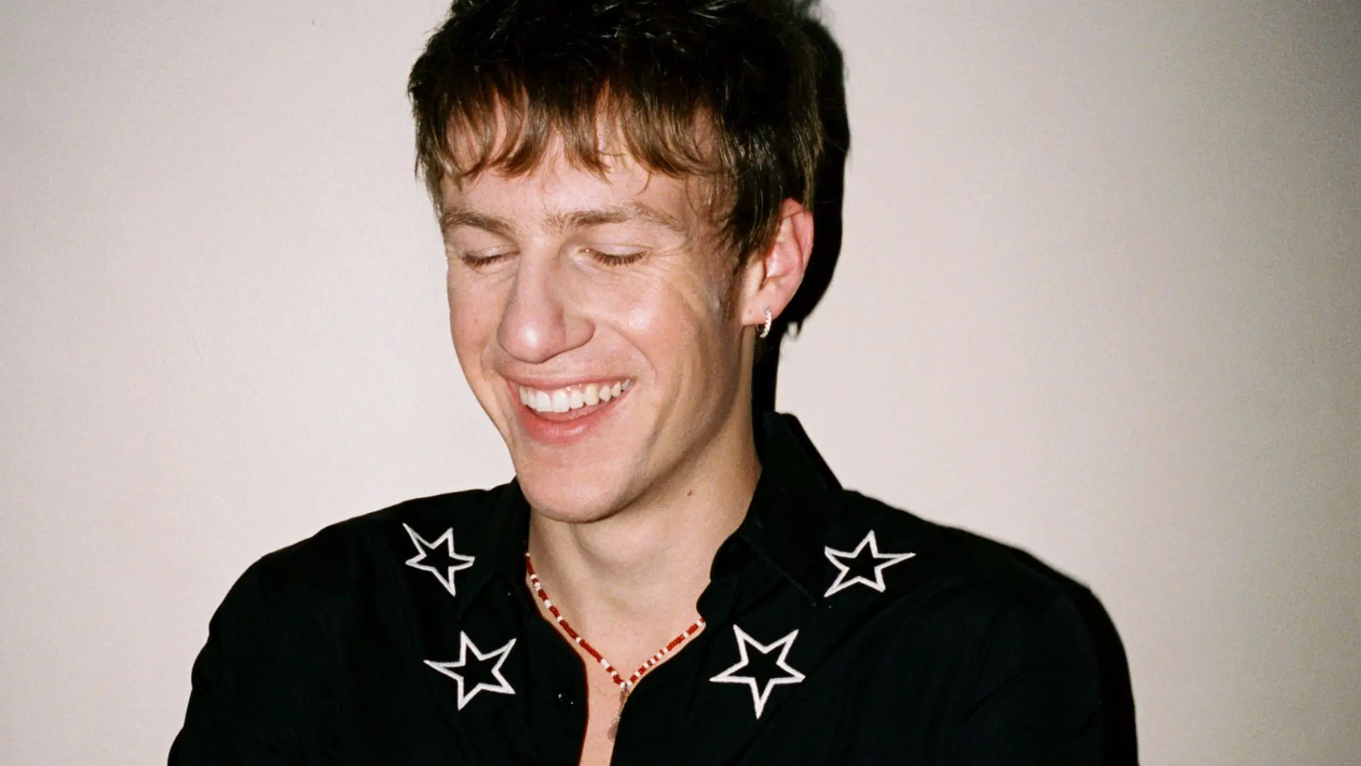 Malcolm Todd in a black shirt with stars in the collar