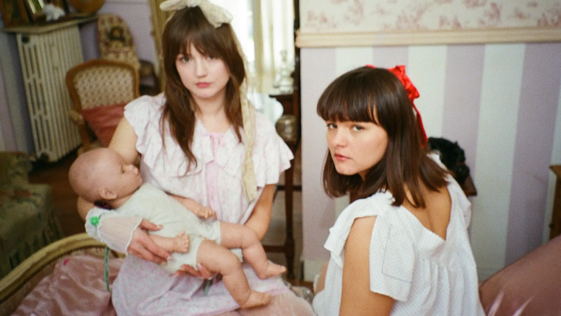 Duo Disgusting Sisters holding dolls