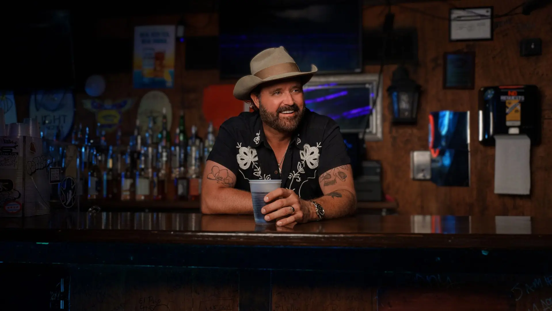 Randy Houser stood behind a bar