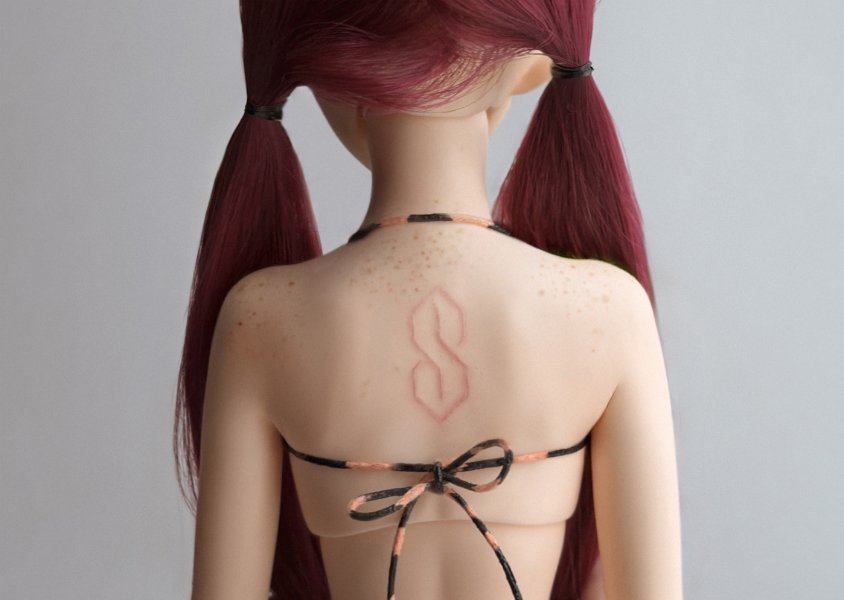 doll with s drawn on her back