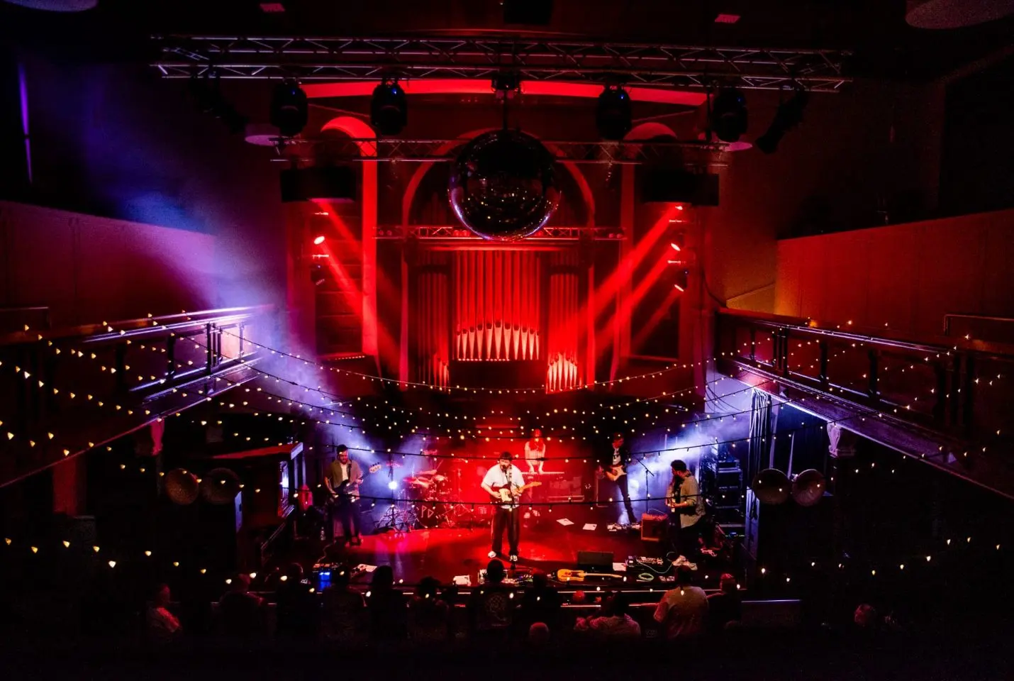 The band The Painting performing in a colourfully lit stage , picture taken from above