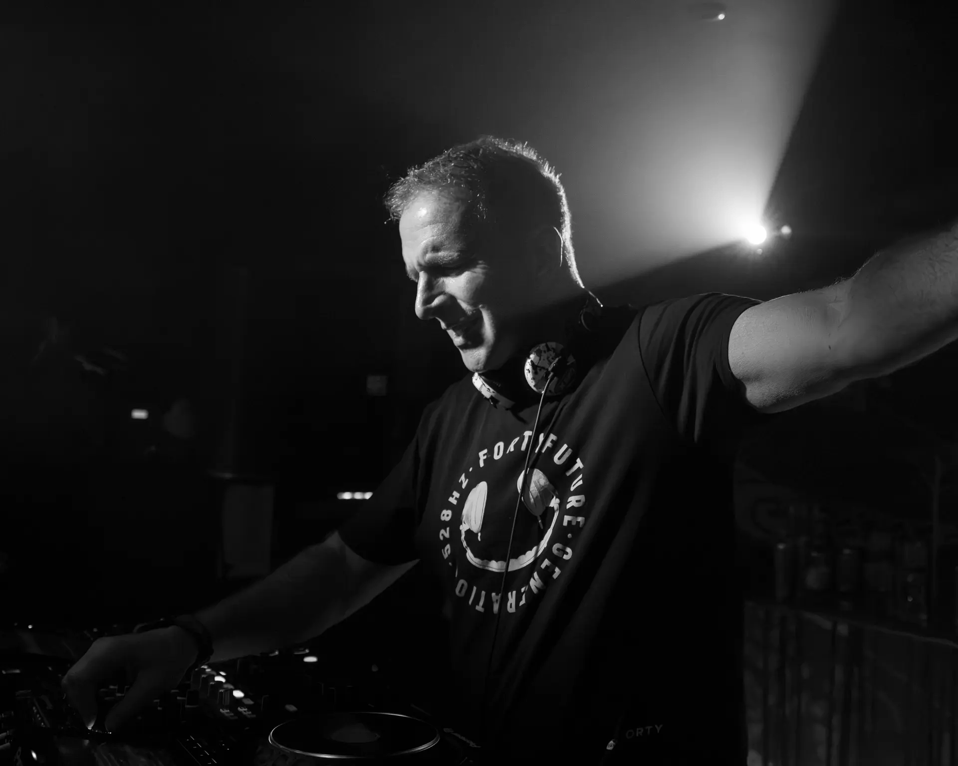 George Bowie, black and white, playing the DJ decks