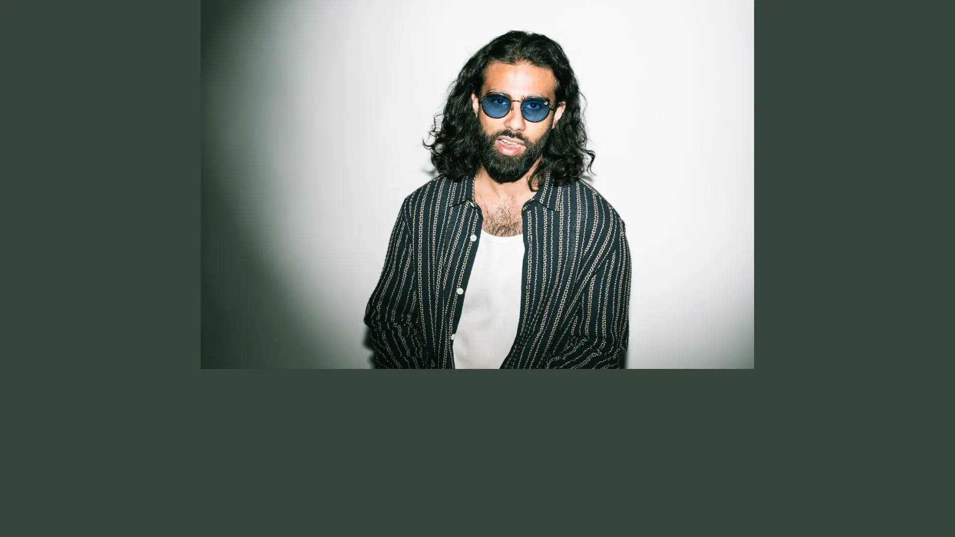 Hyphen in a striped shirt and white tshirt