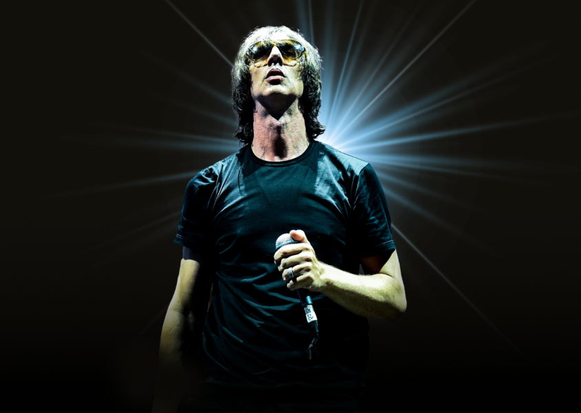 Richard Ashcroft holding a microphone