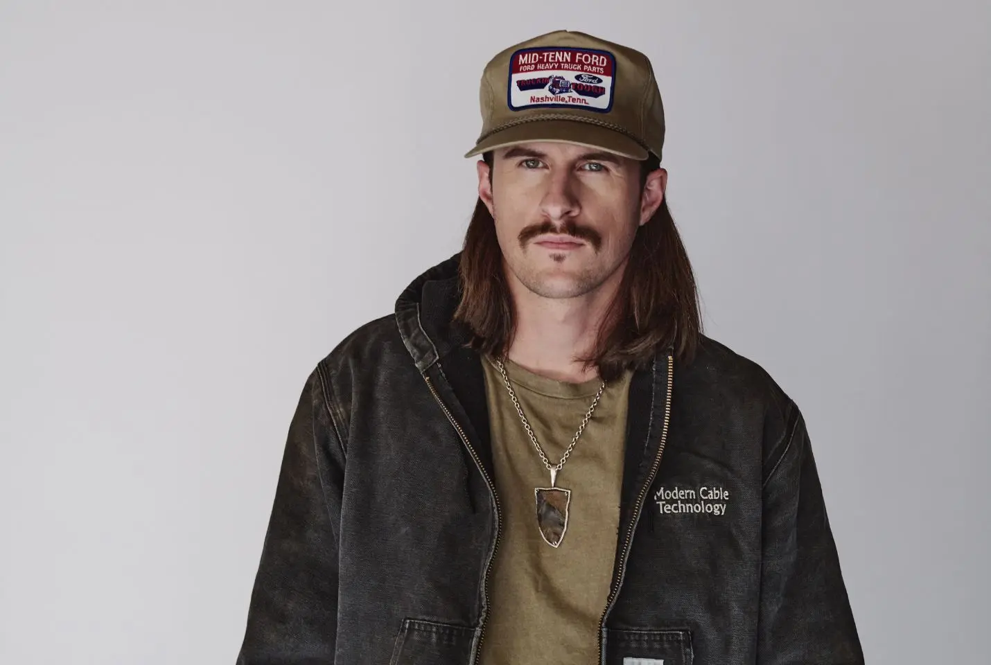 John Morgan in a black jacket and green cap