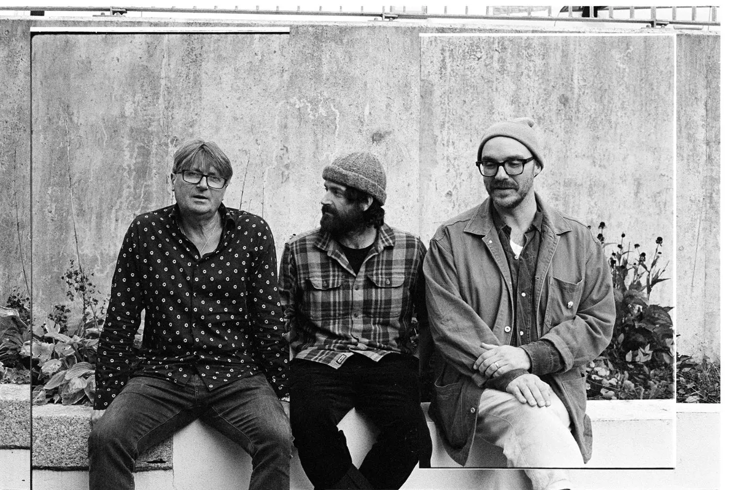 Band members of LYR sat on a wall