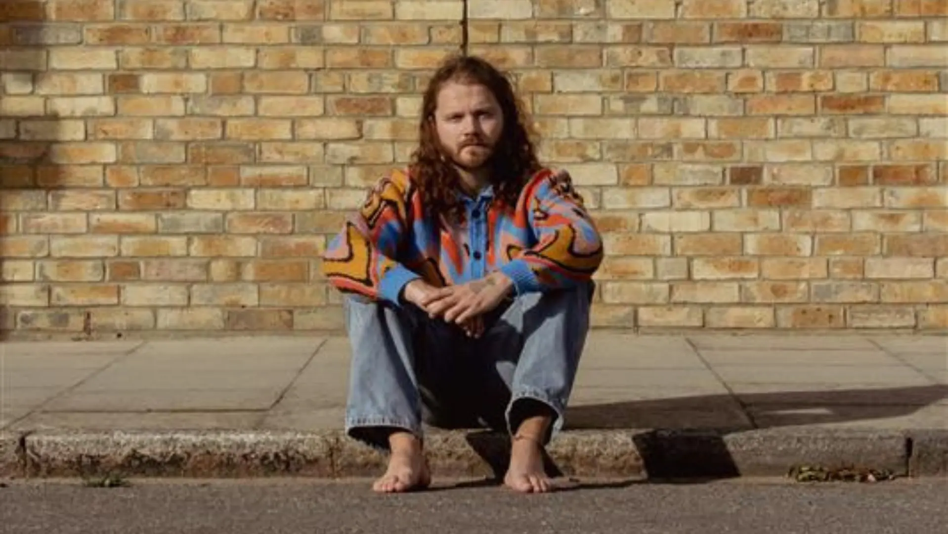 Brodie Barclay sat on the side if a pavement