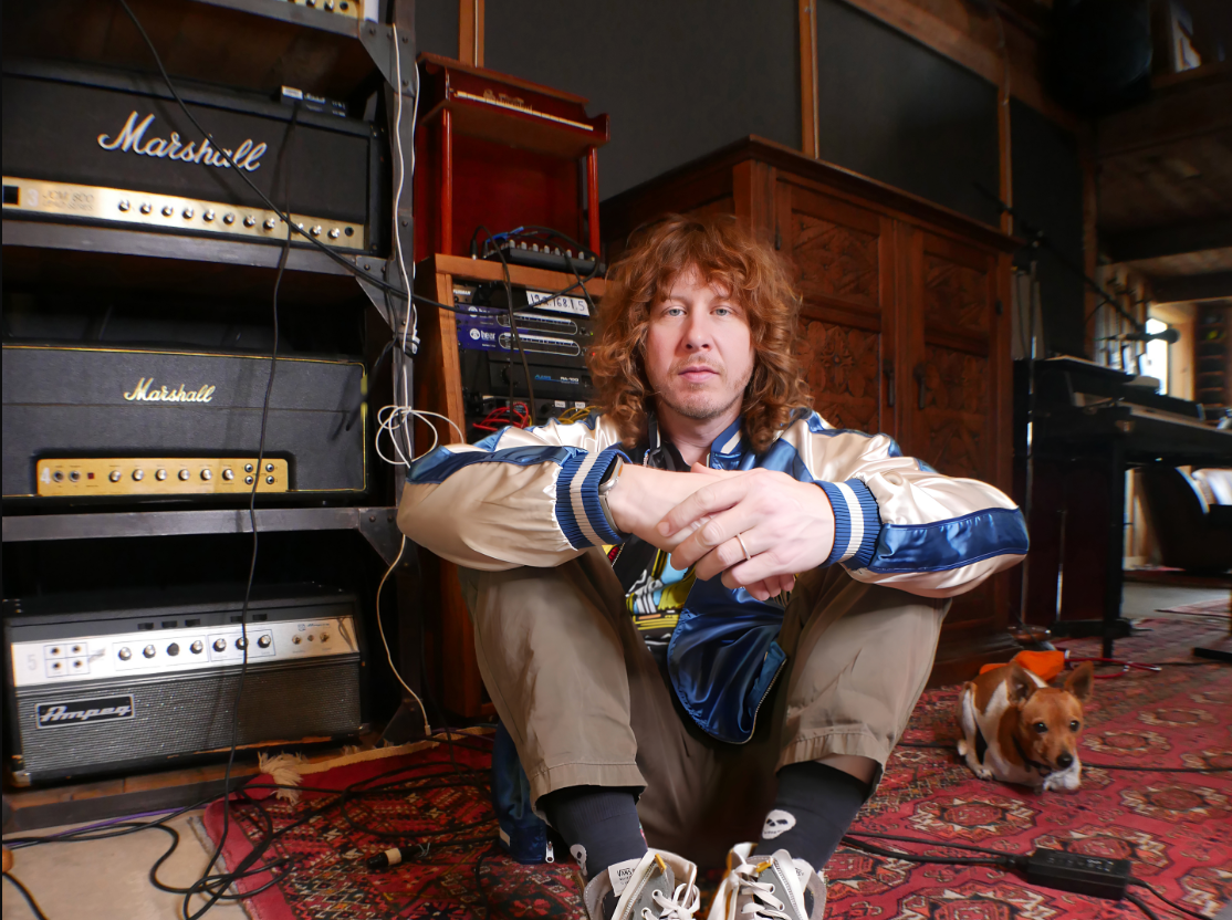 Ben Kweller next to speakers