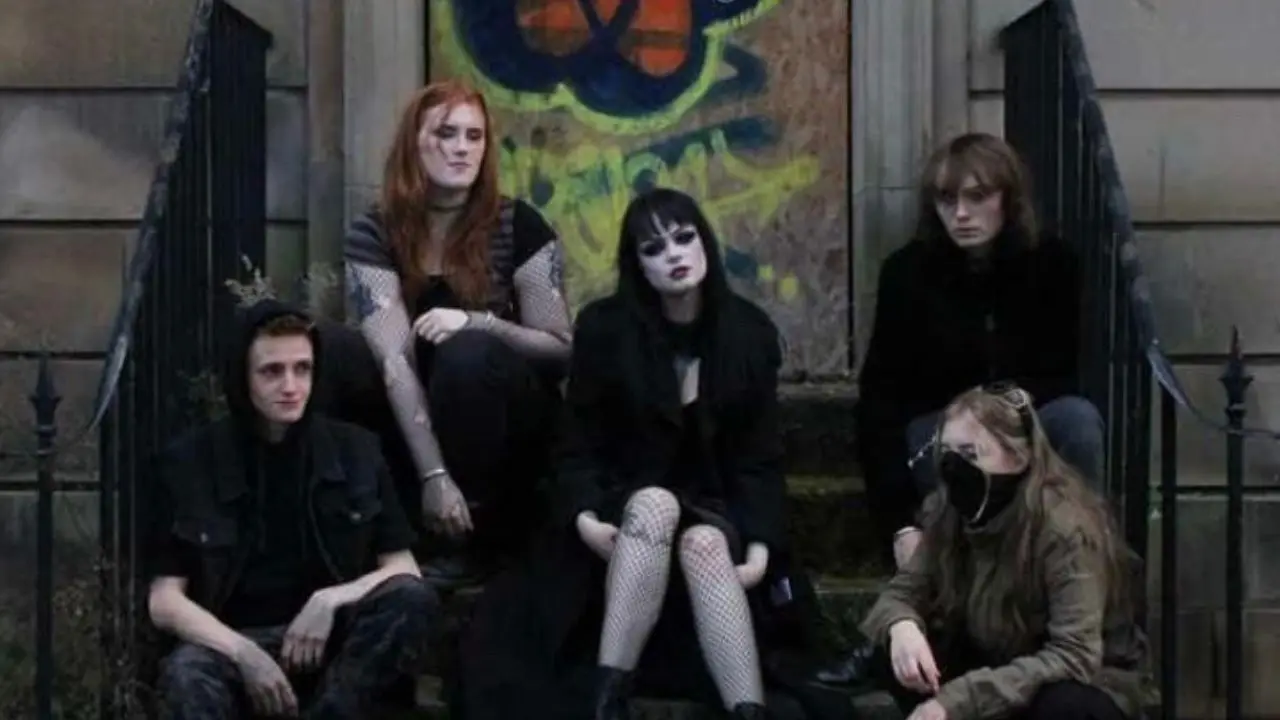 band sitting on steps outside