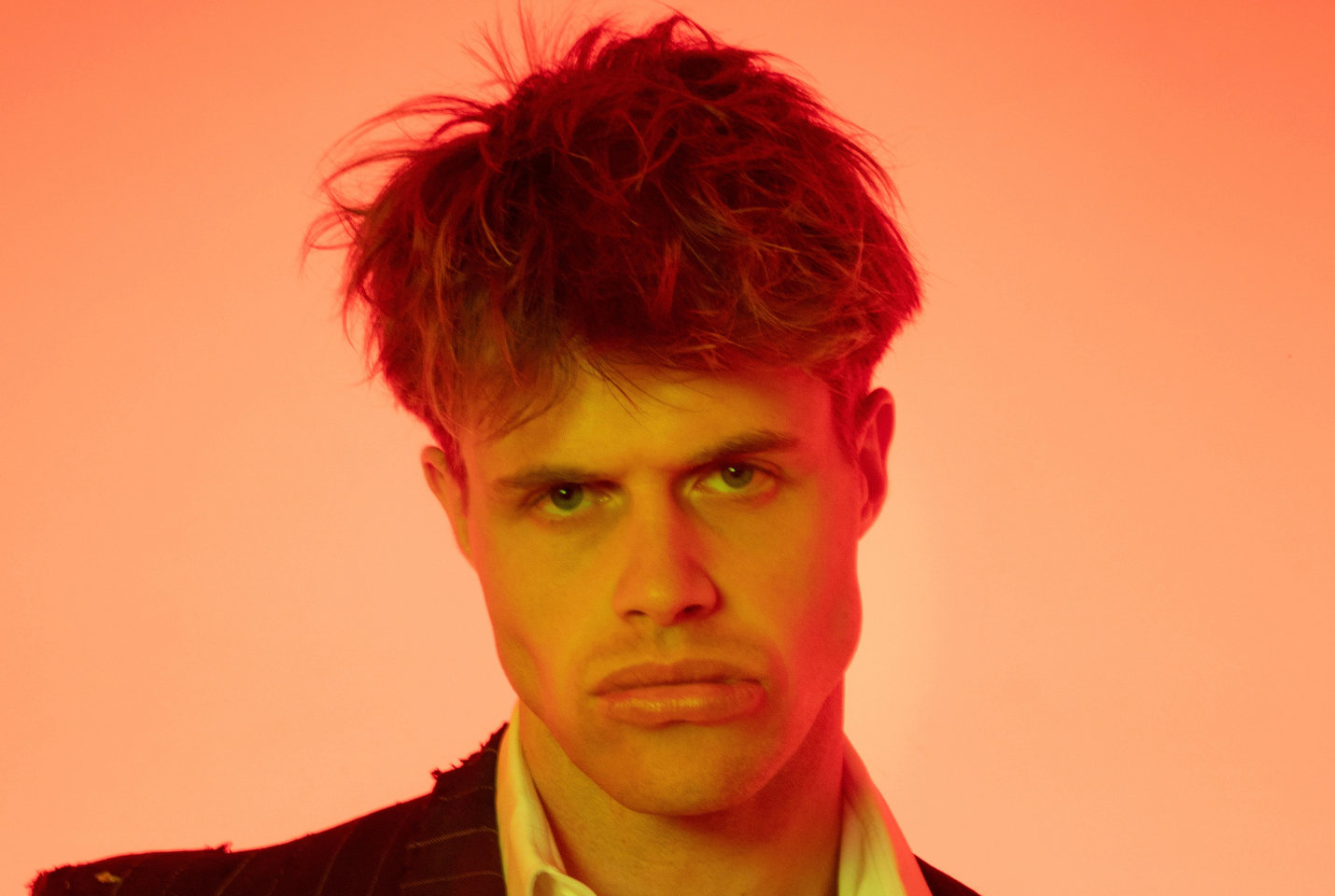 Headshot of a man with orange background