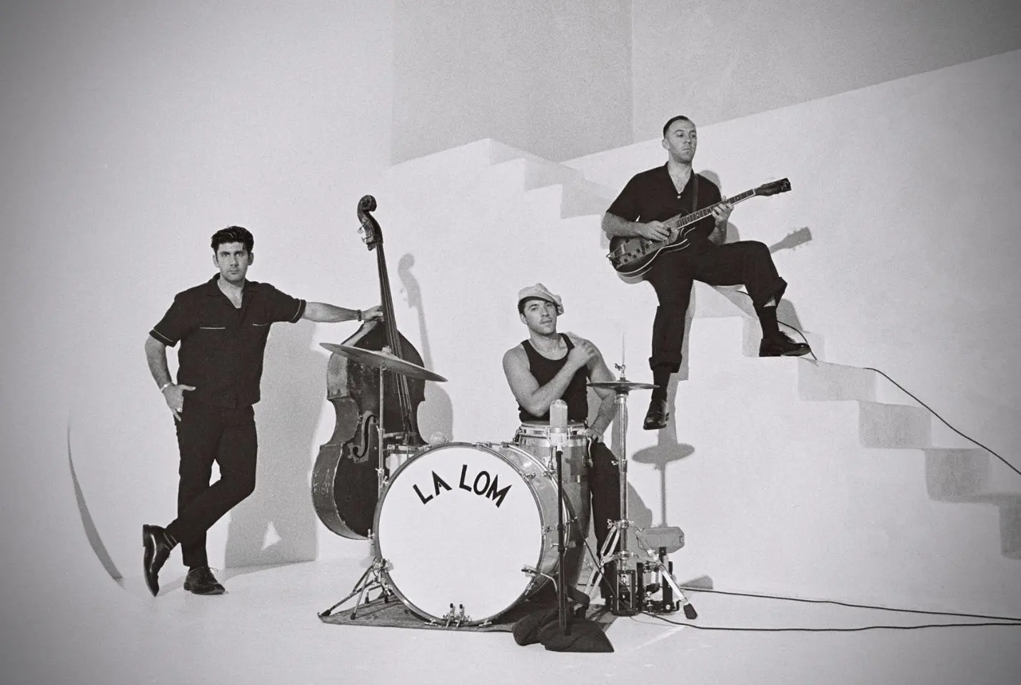 Black and white image of three men with instruments