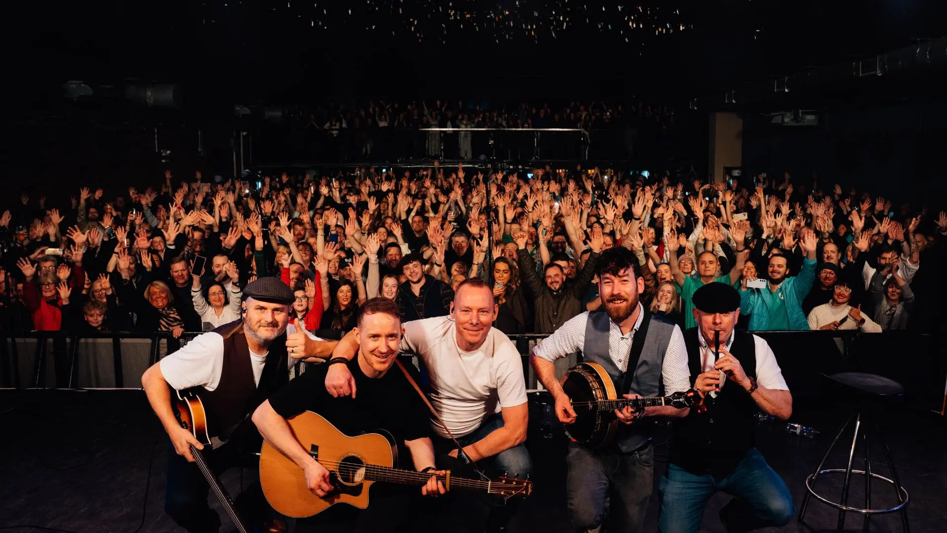 The Highstool Prophets on stage with a crowd behind them