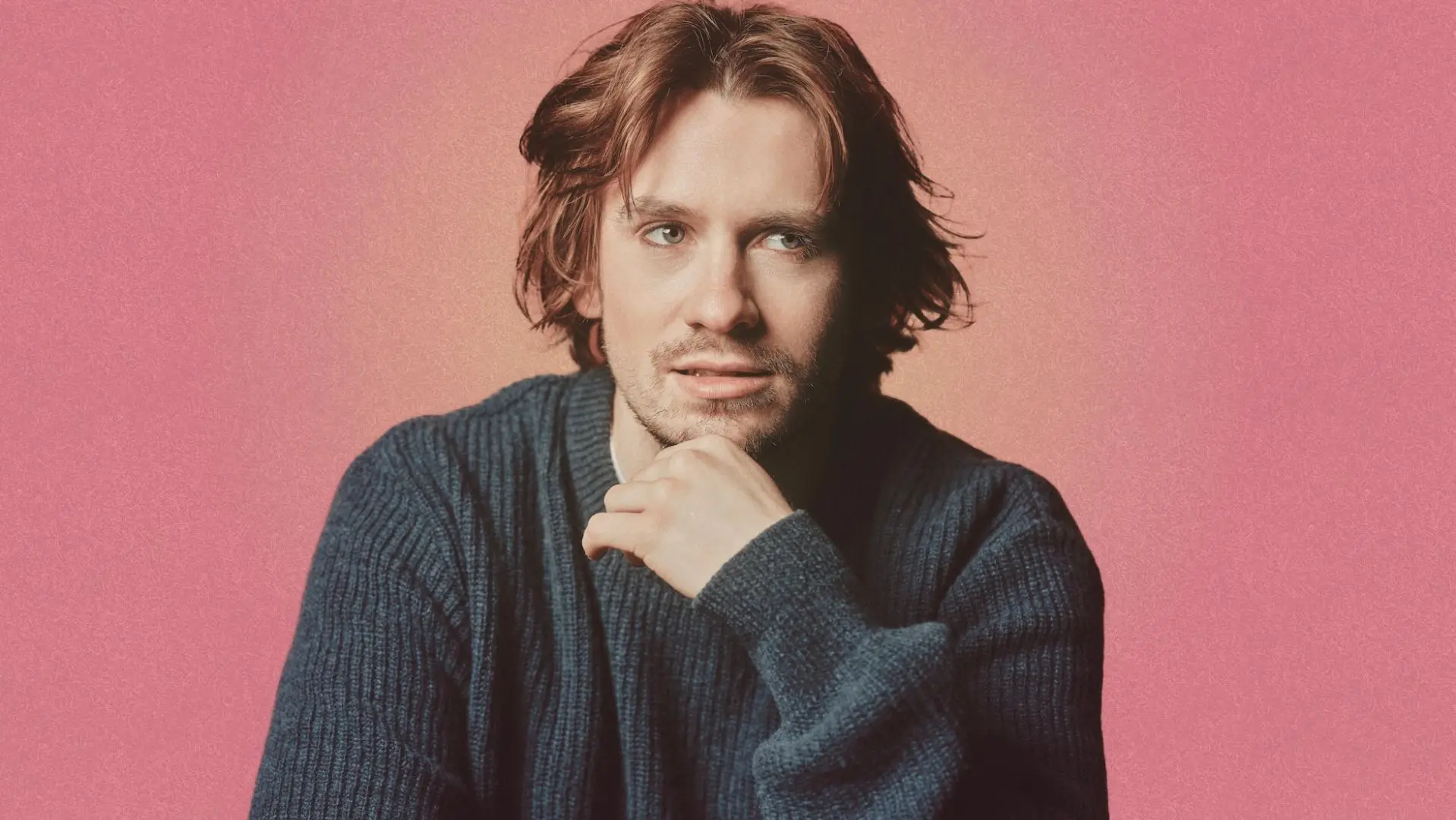 JP O'Grady in front of a pink background