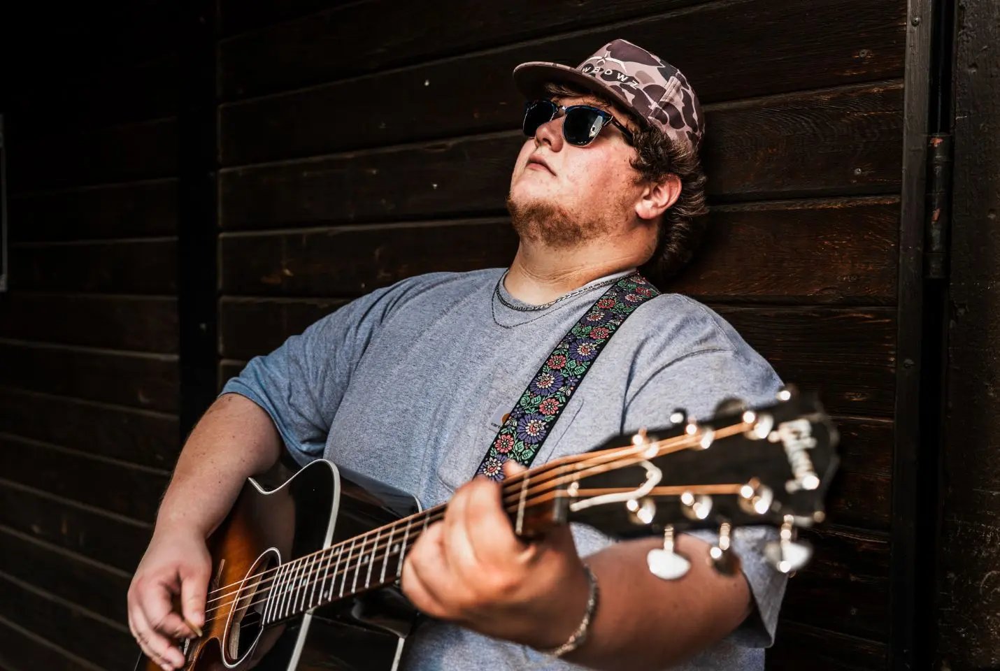 Bayker Blankenship playing a guitar