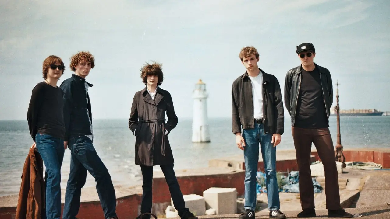 Five men stood on a pier