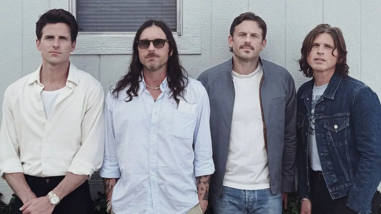 Members of the band Kings of Leon standing in front of a building
