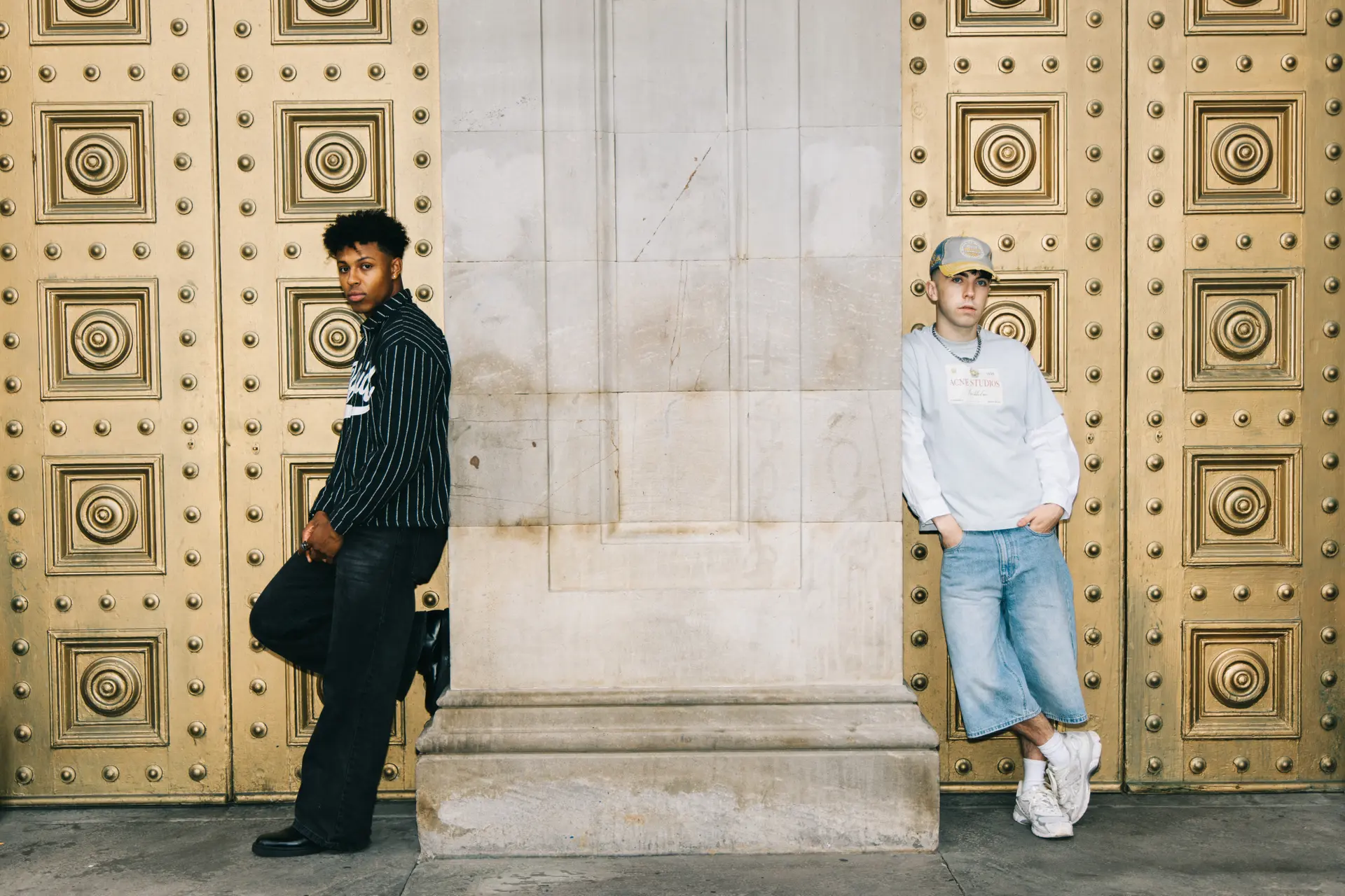 two men leaning angainst a wall