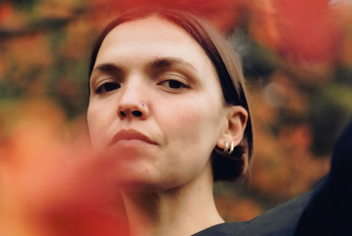 A woman with short brown hair and silver earrings