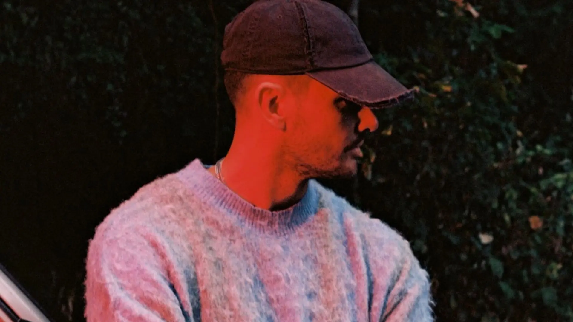 Producer Rules in a blue jumper and black cap