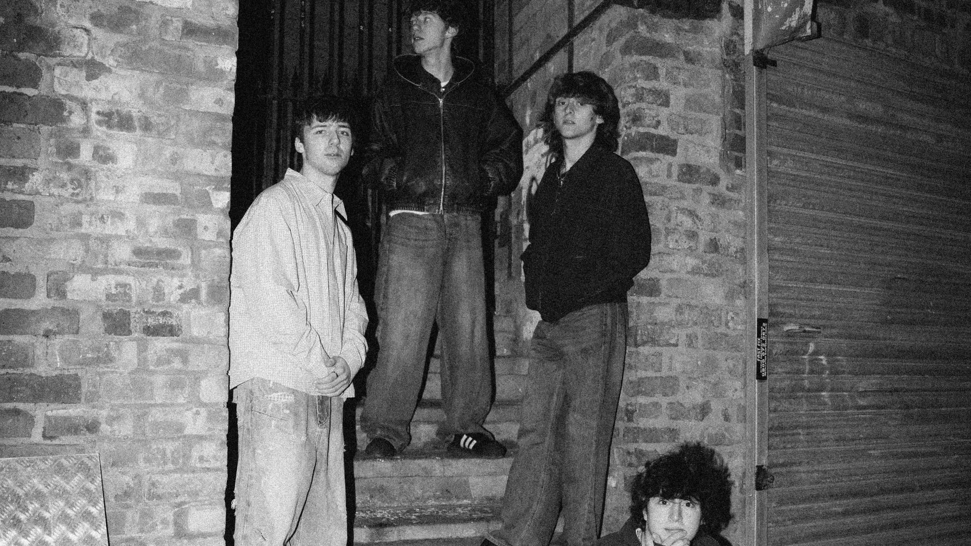 Black & White image of Florentenes sat on a door step