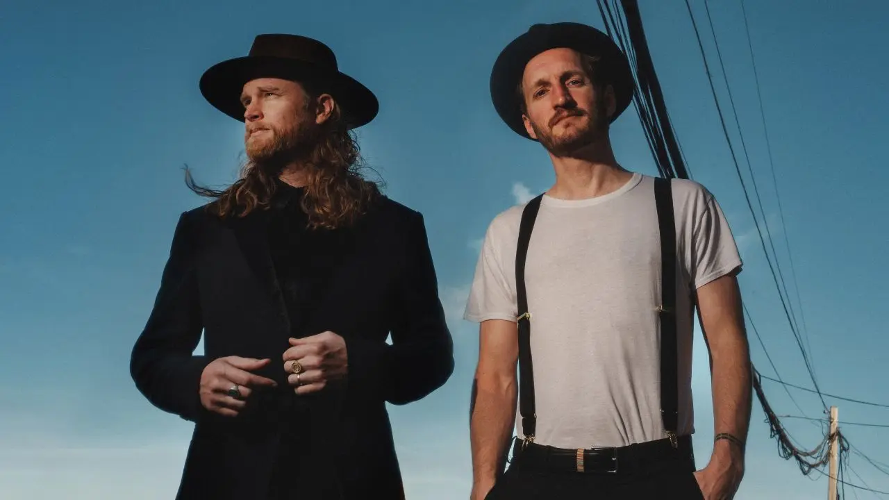 Band The Lumineers with a blue sky as the background