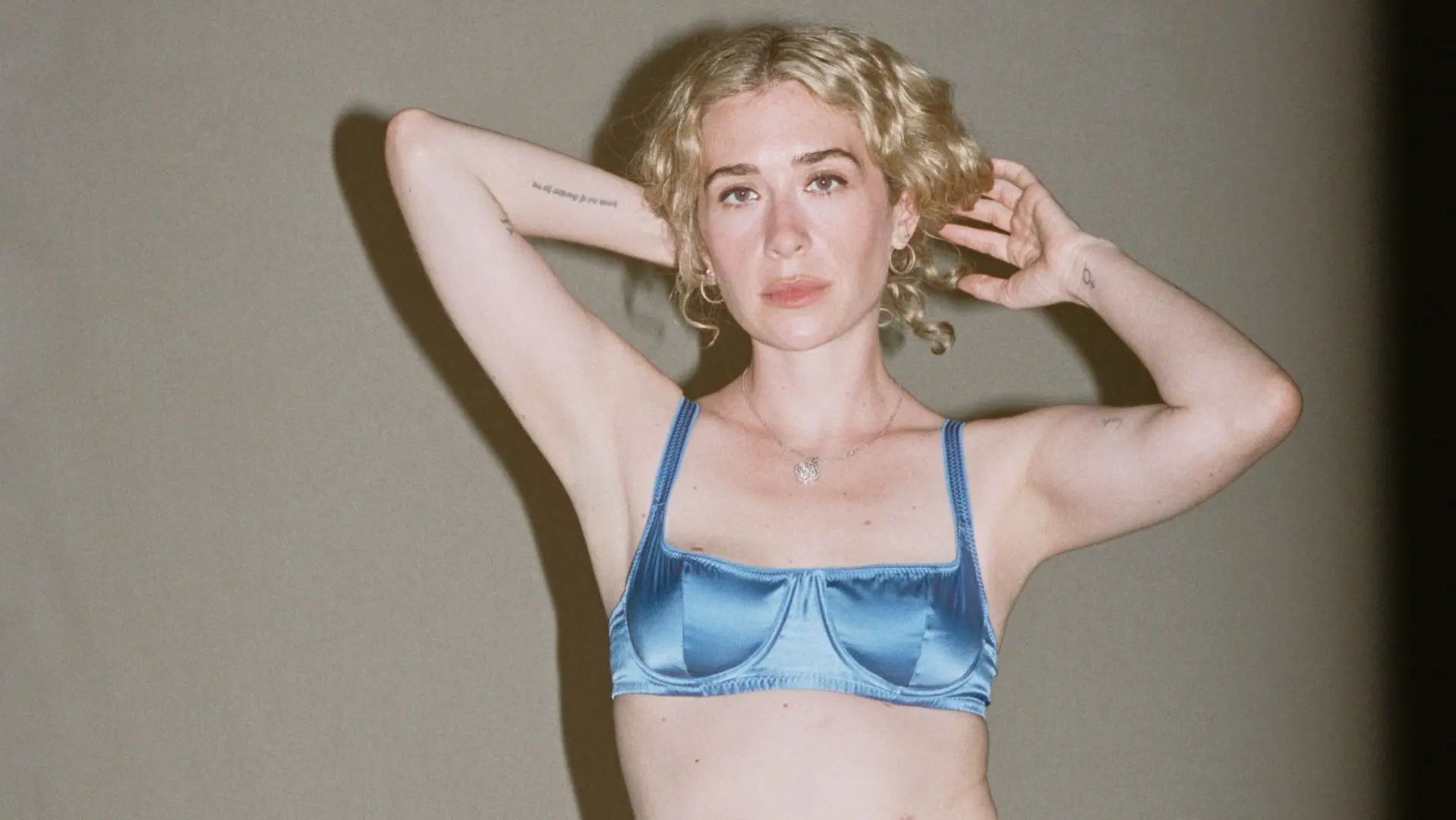 Blondshell wearing a blue satin bra