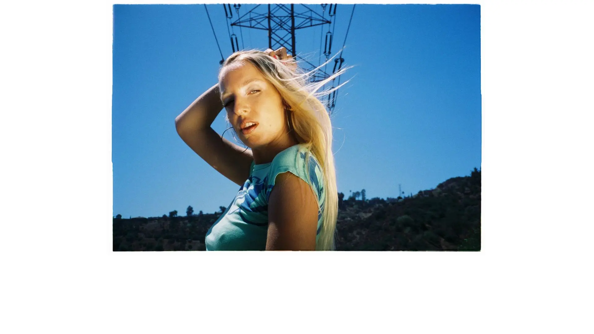 Maude Latour posing in front of a blue sky