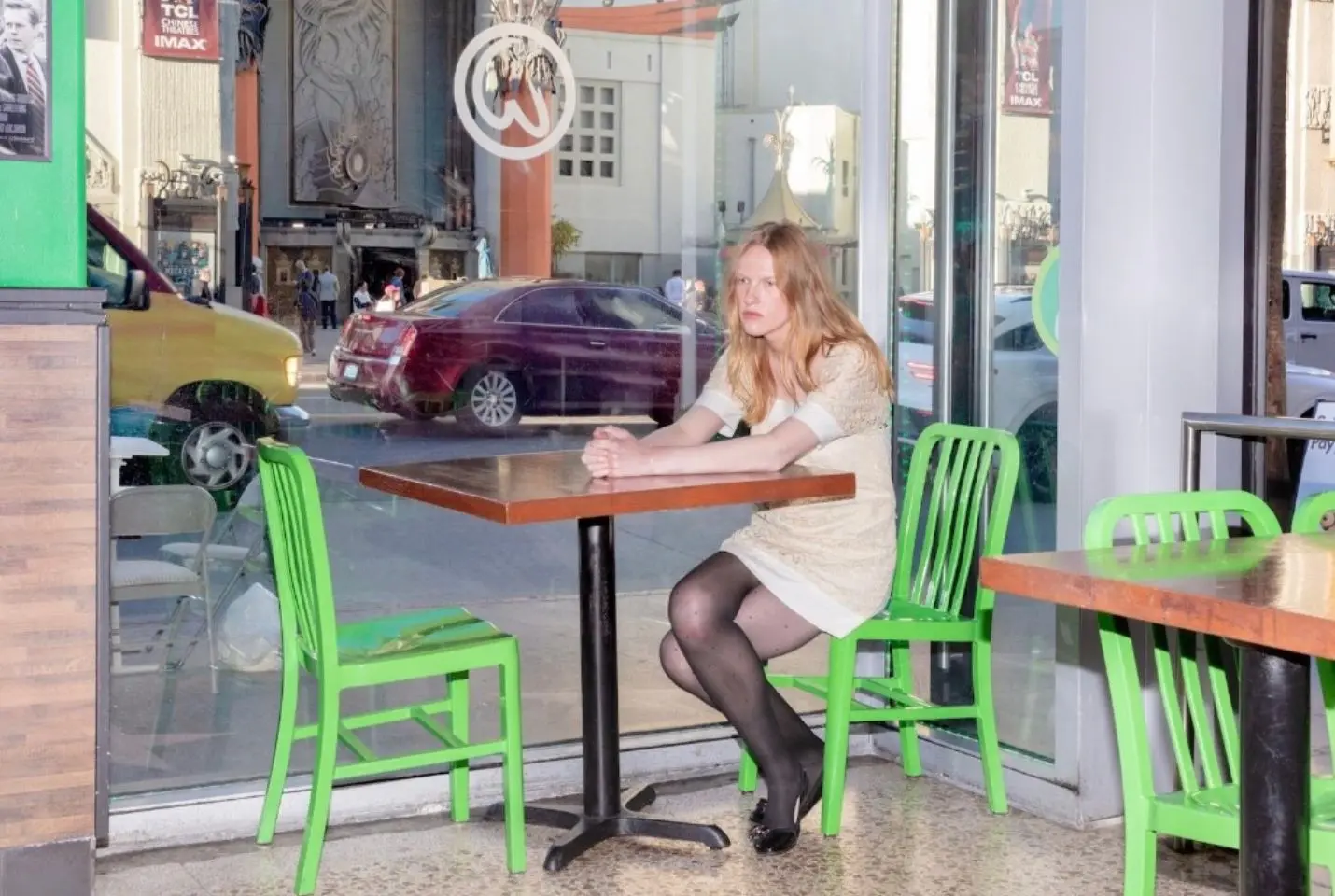 A woman sat alone at a window table for two