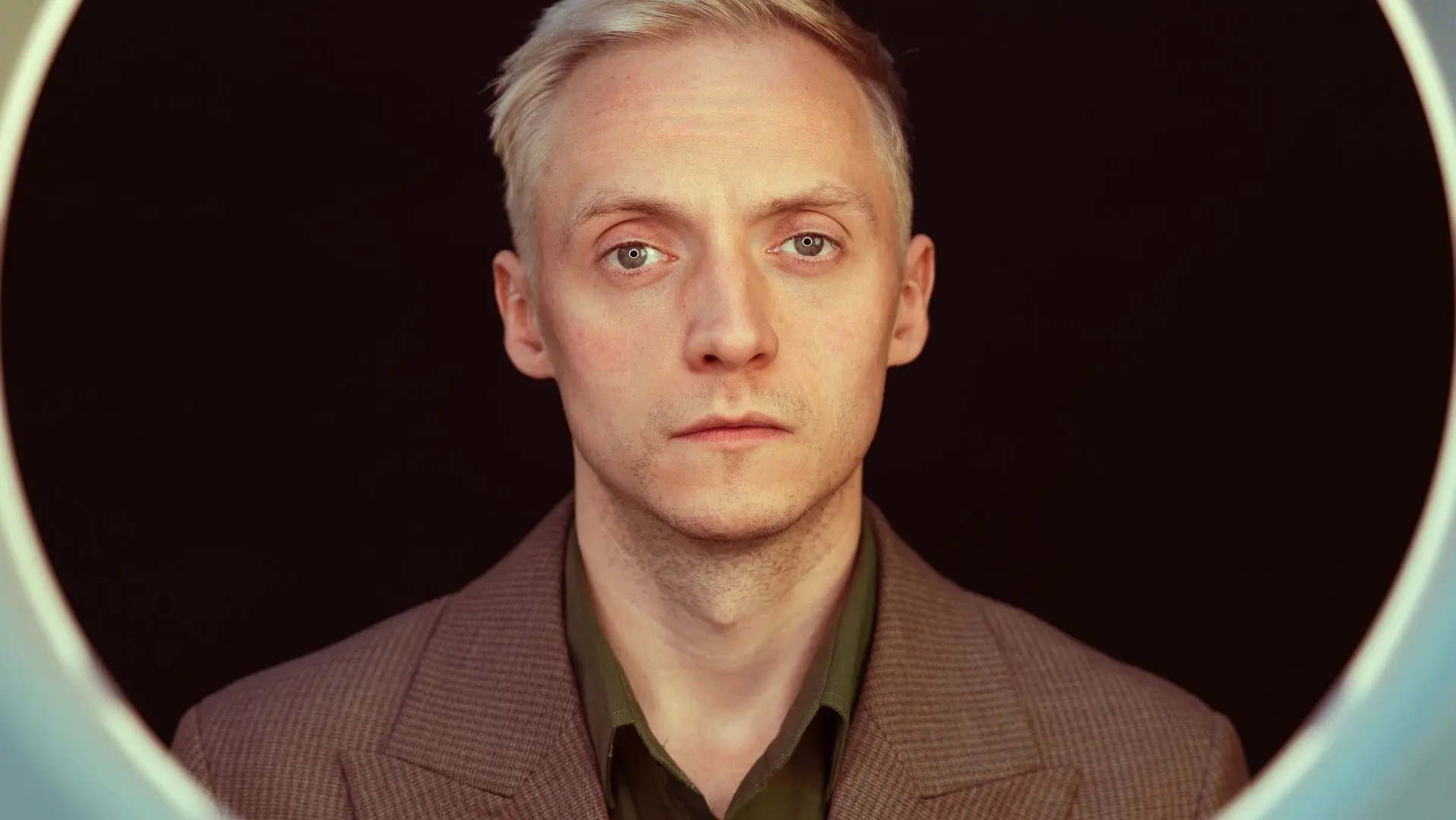 Hamish Hawk in a brown suit