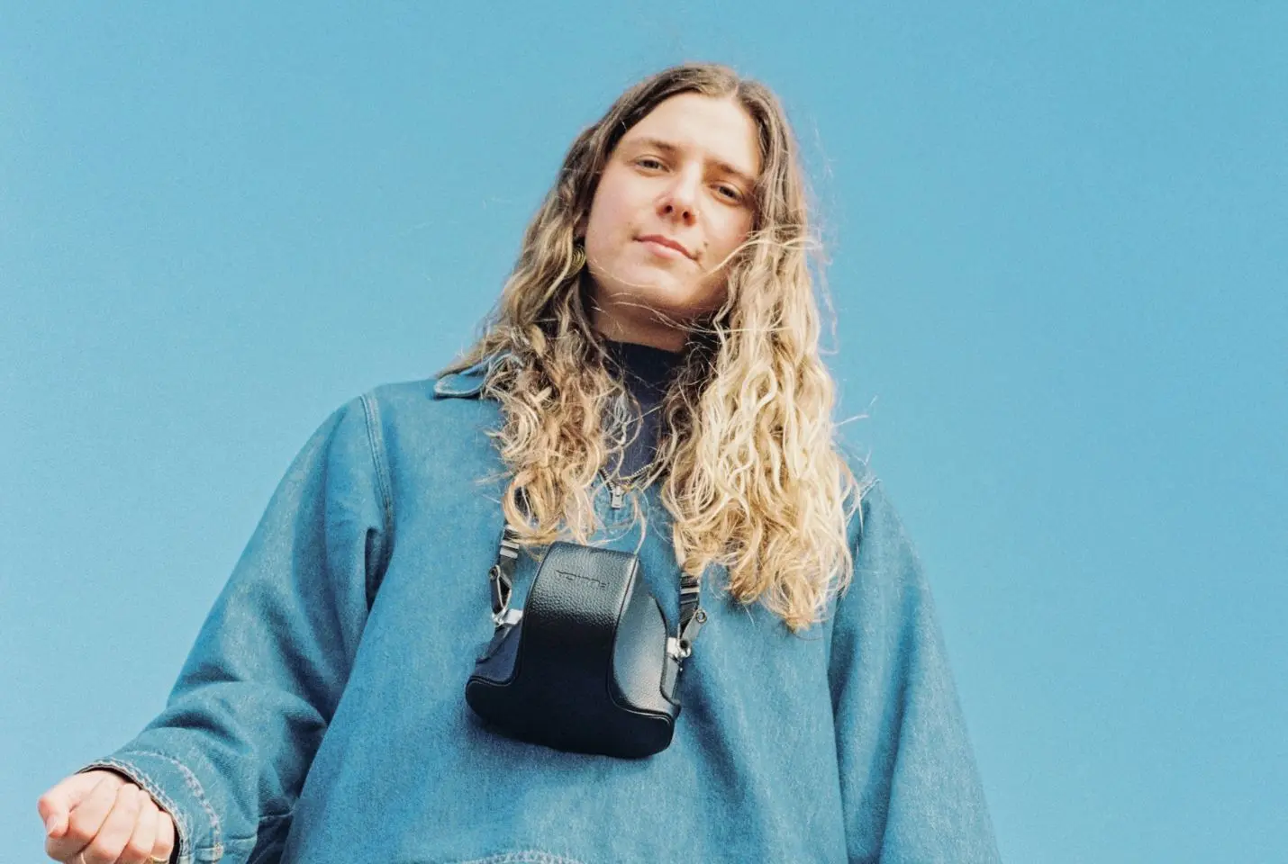 Rosie H Sullivan wearing a blue denim jacket with a camera around her neck