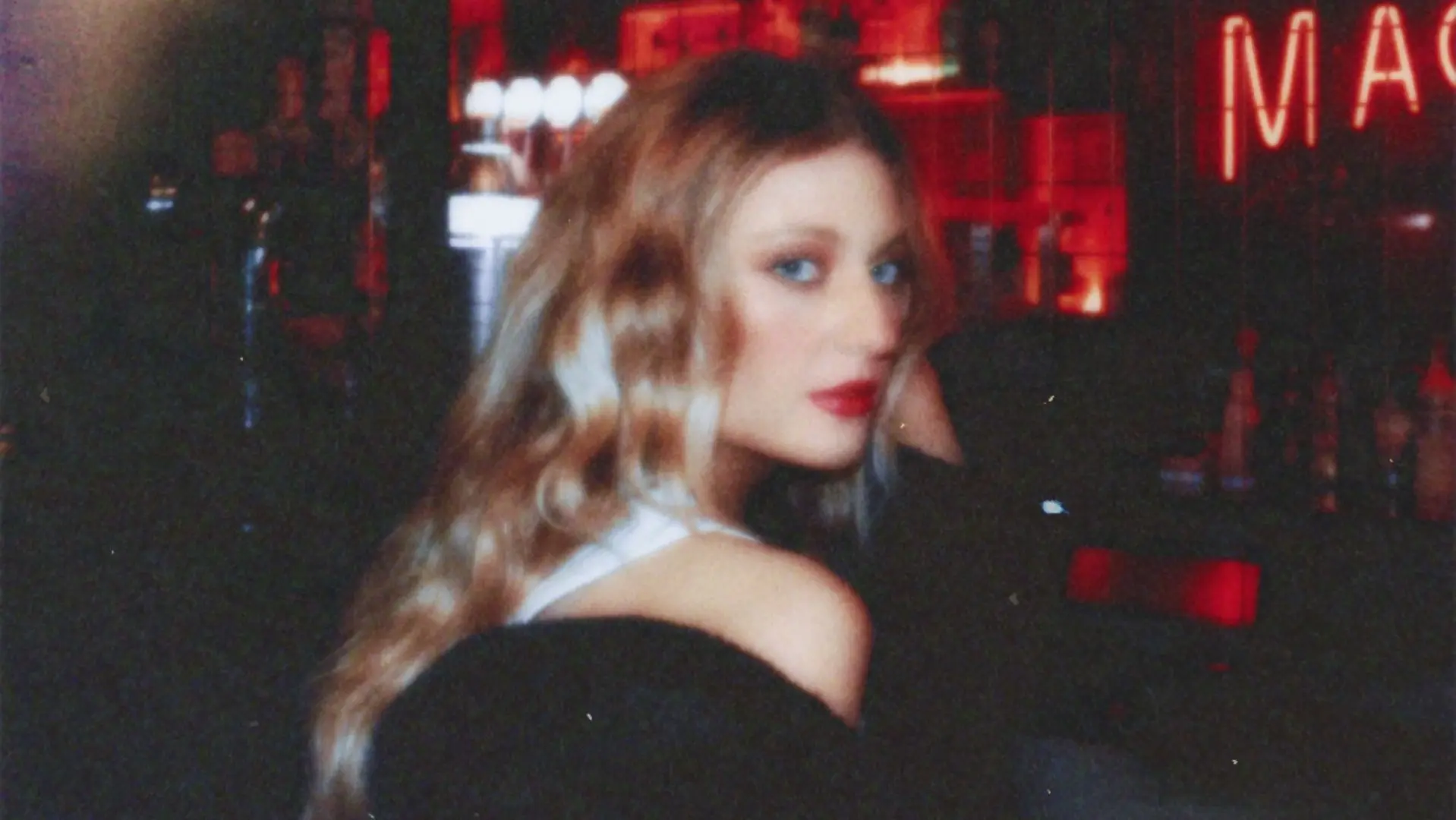 Riley sat at a bar with long blonde hair