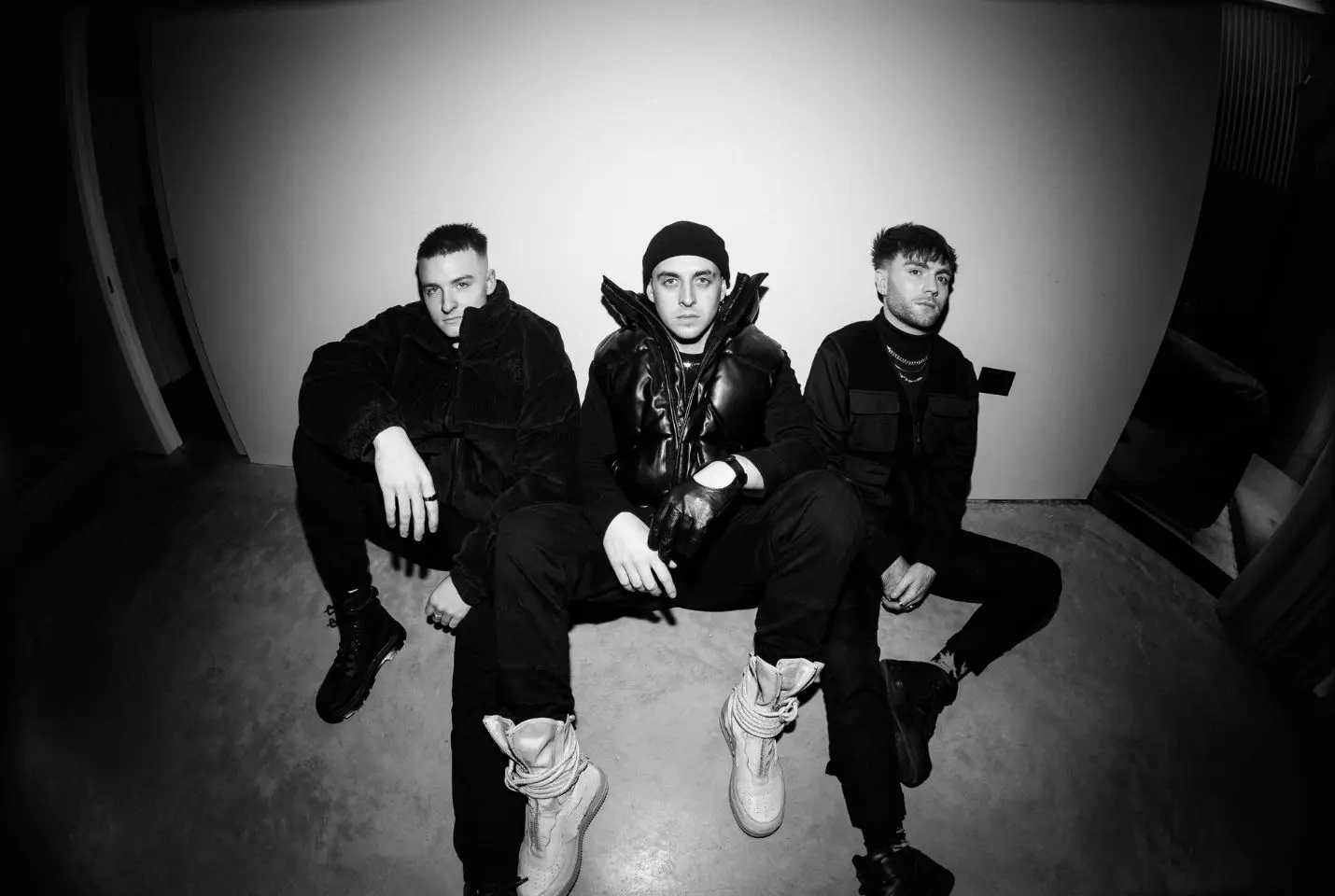 Three man sat on the ground