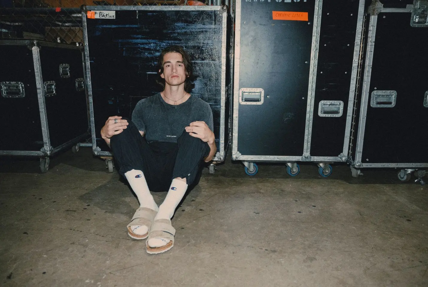 Chance Peña sat in front of some flight cases