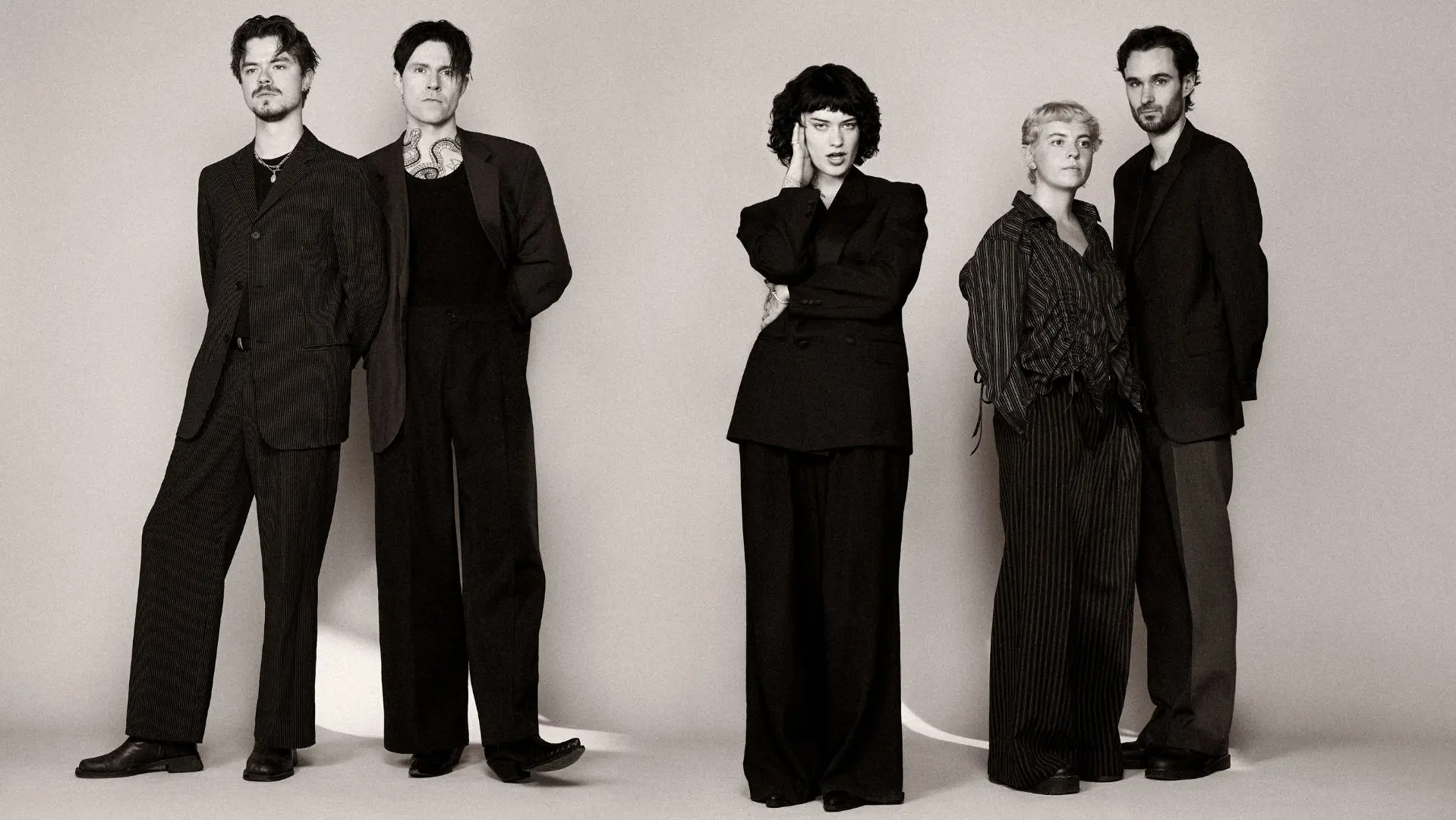 Girl In The Year Above band all dressed in black