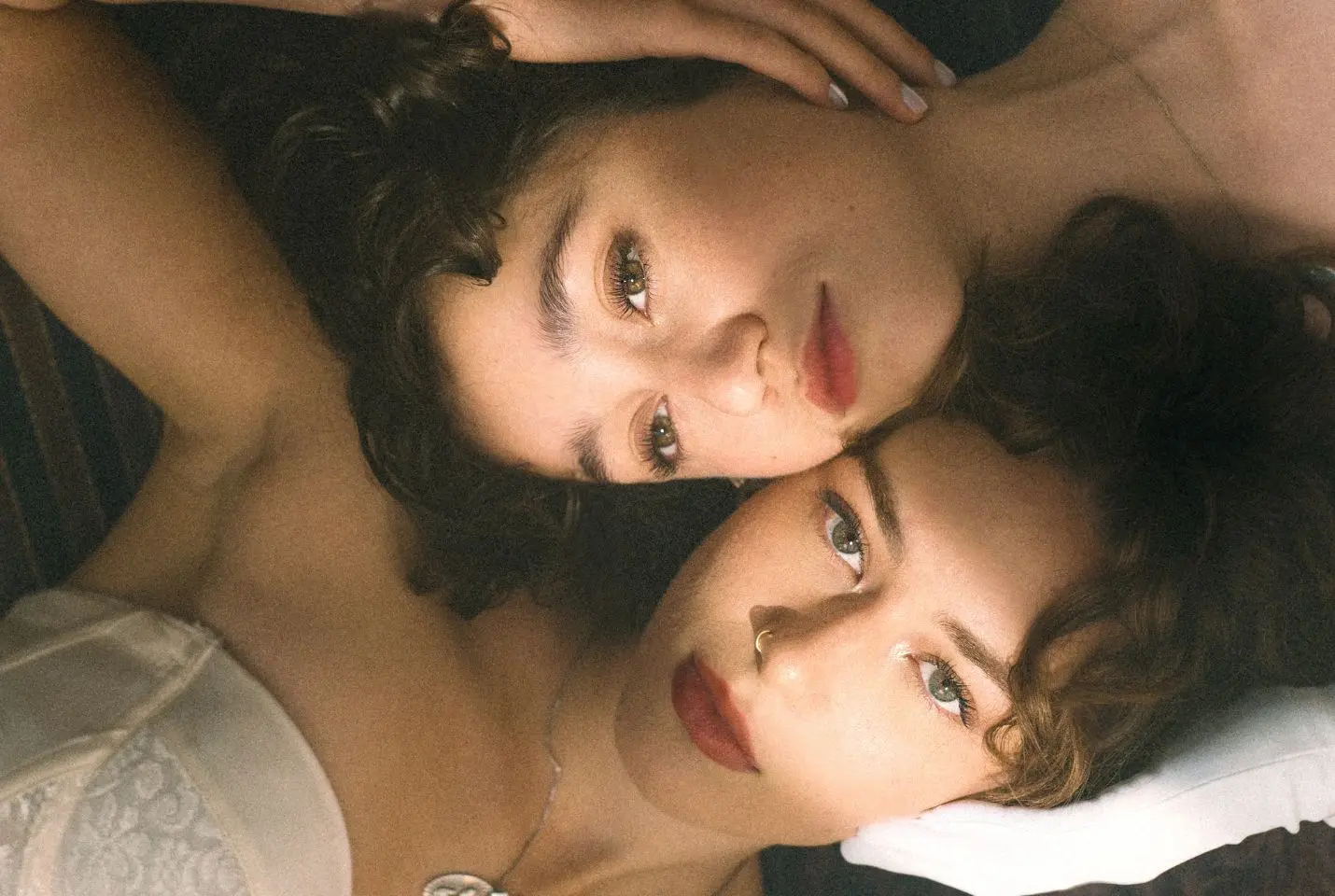 Close up image of duo Lumi lying with their heads next to each other