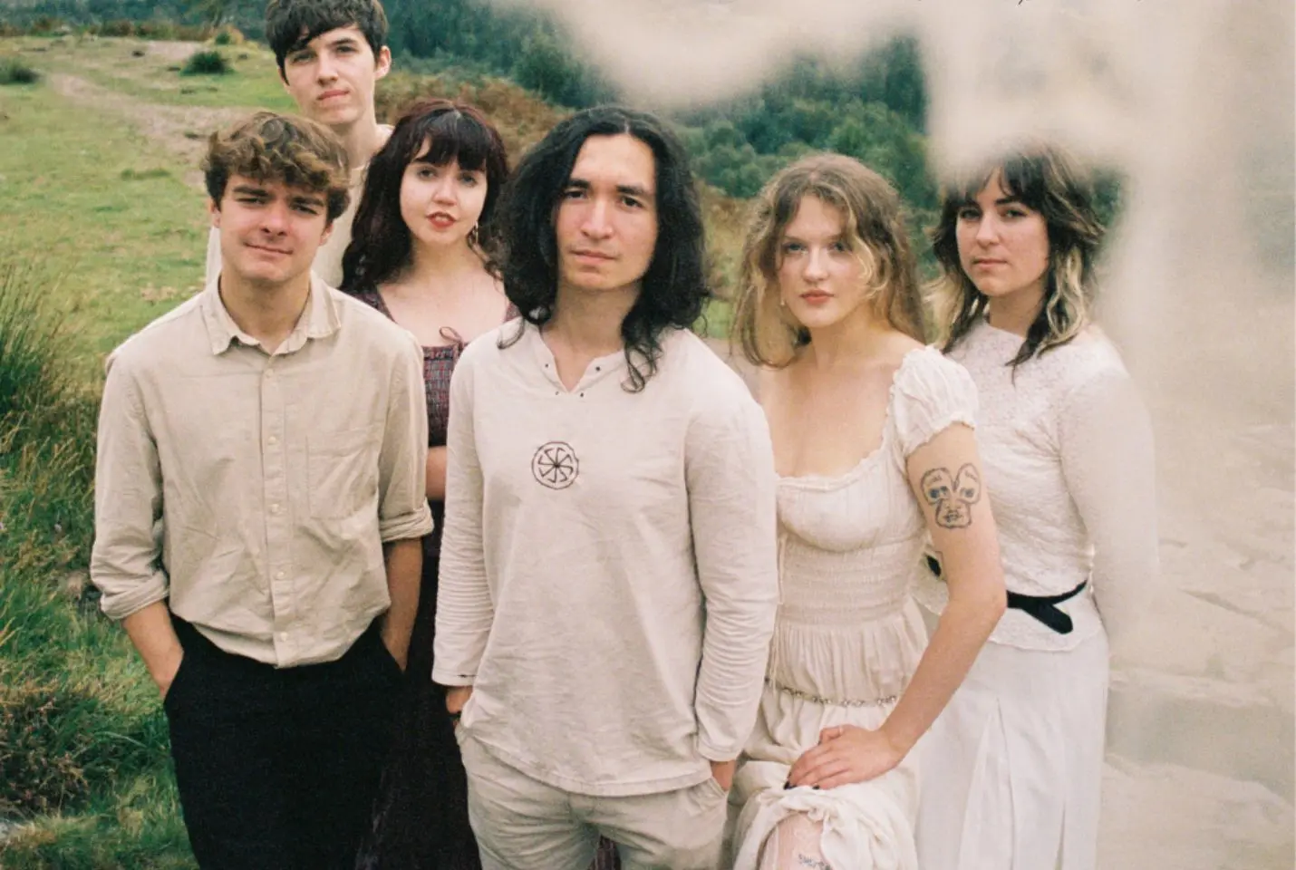 band of 6 people posing with scenic background