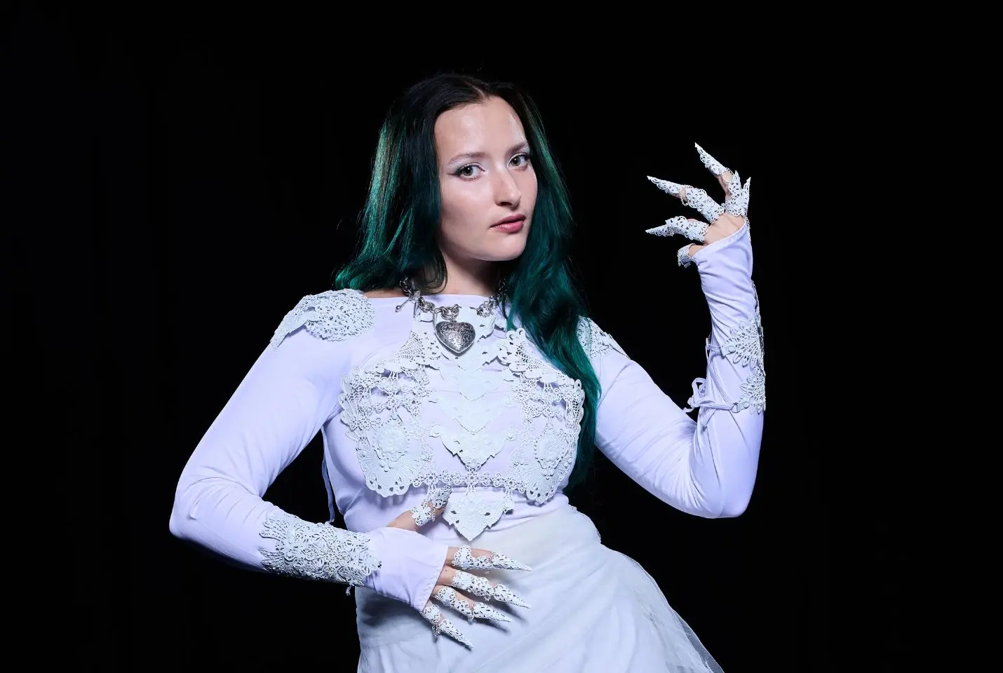 au/ra wearing white dress with long nails in front of dark wall