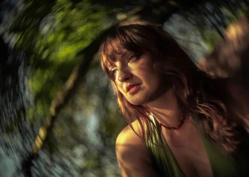 Madison Cunningham staring away from the camera wearing a green top