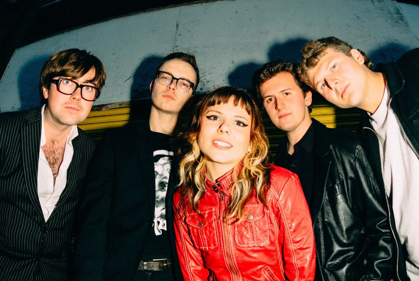 band posing , 4 men, 1 woman