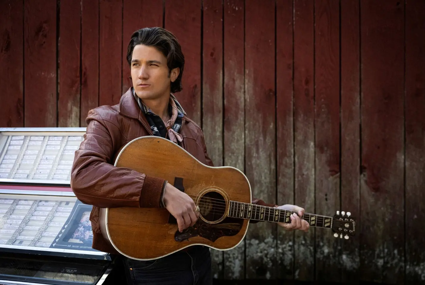 Drake Milligan holding a guitar