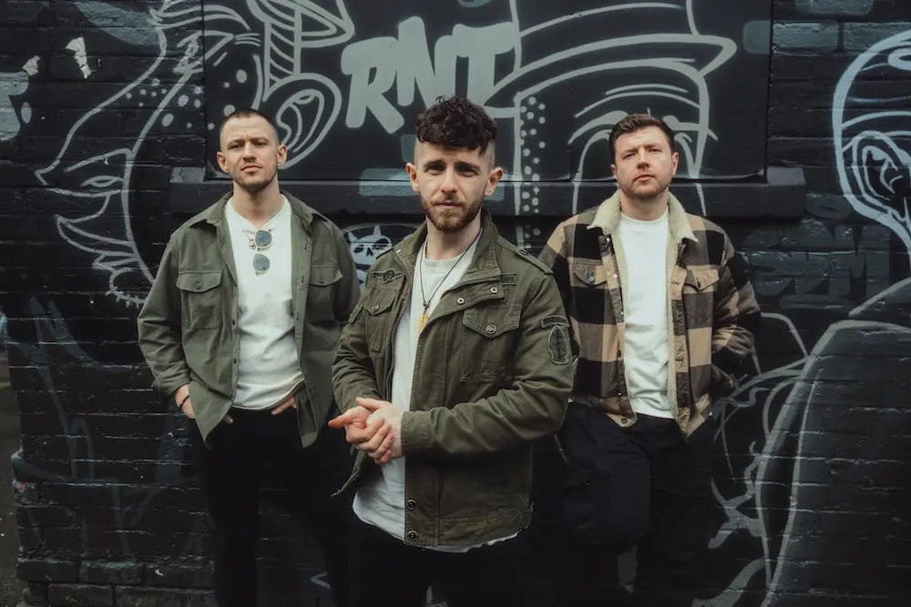 Anchor Lane posing in front of graffiti