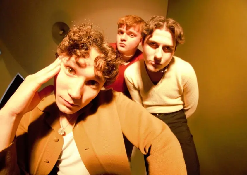 3 men in dim lighting