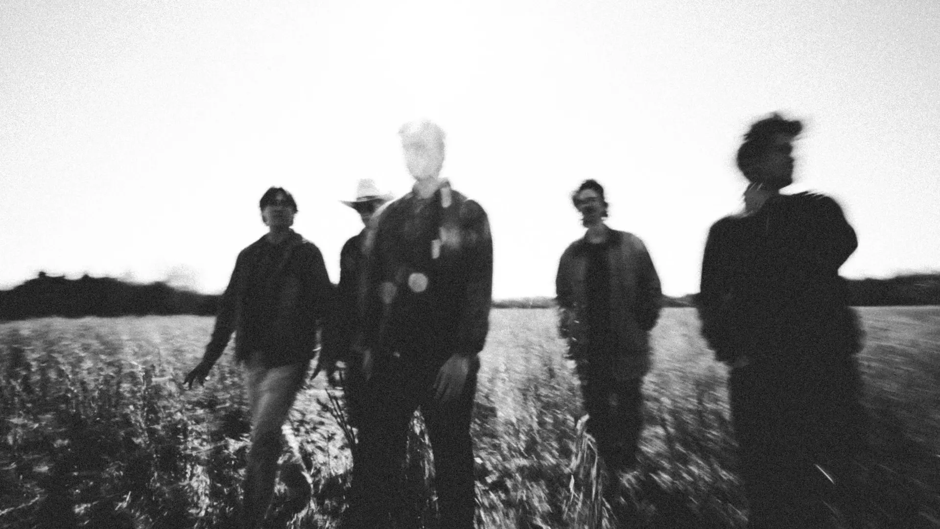 band standing in wheat field
